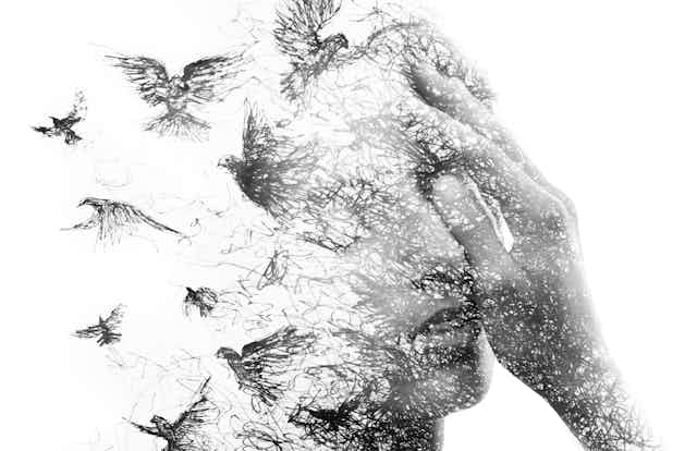 A face dissolves into birds.