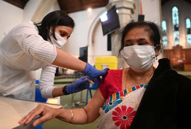 A woman being vaccinated for COVID-19