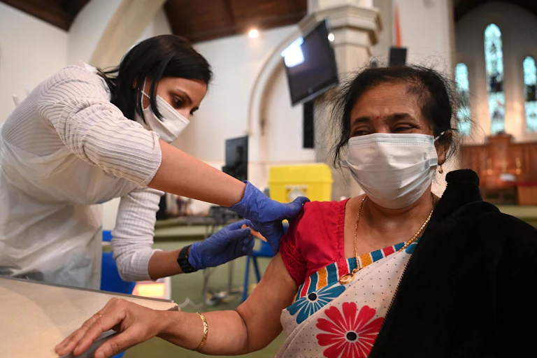 A woman being vaccinated for COVID-19