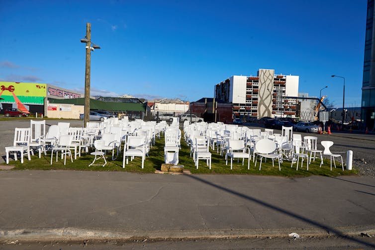 Empty white chairs in an abandoned city square