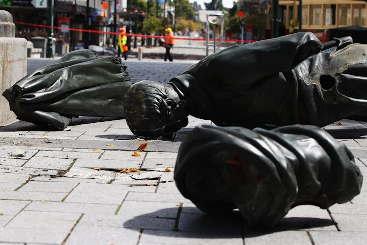 broken statue on the ground