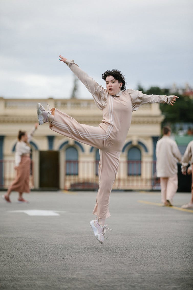 Dancer in open air performance mid leap