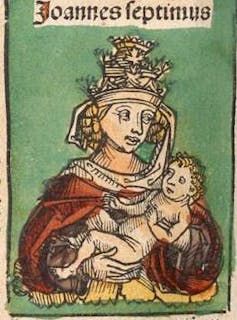 A woman holds a baby