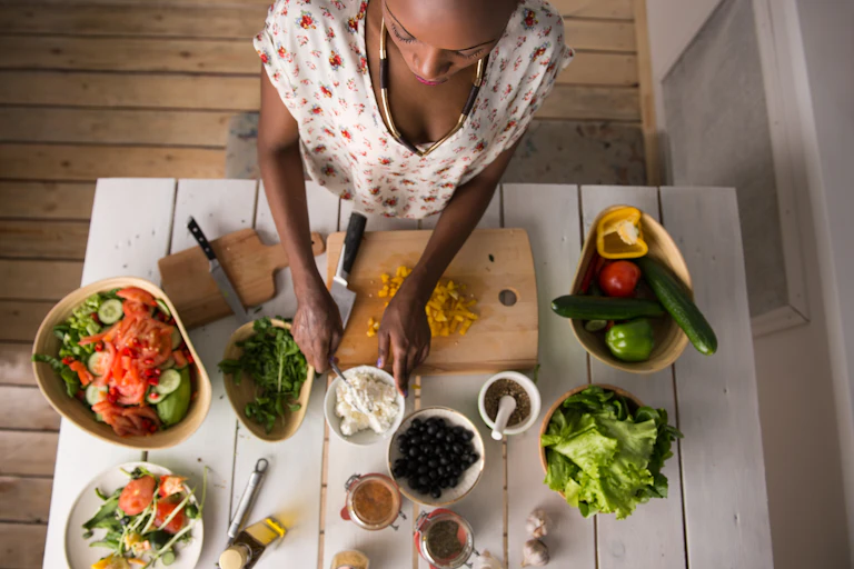 Woman prepares food in her kitchen.