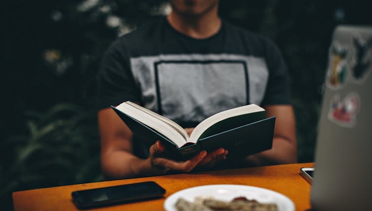 A person reading at a table.