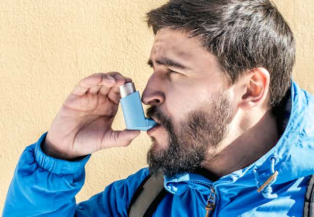 A man using an inhaler