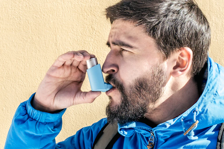 A man using an inhaler