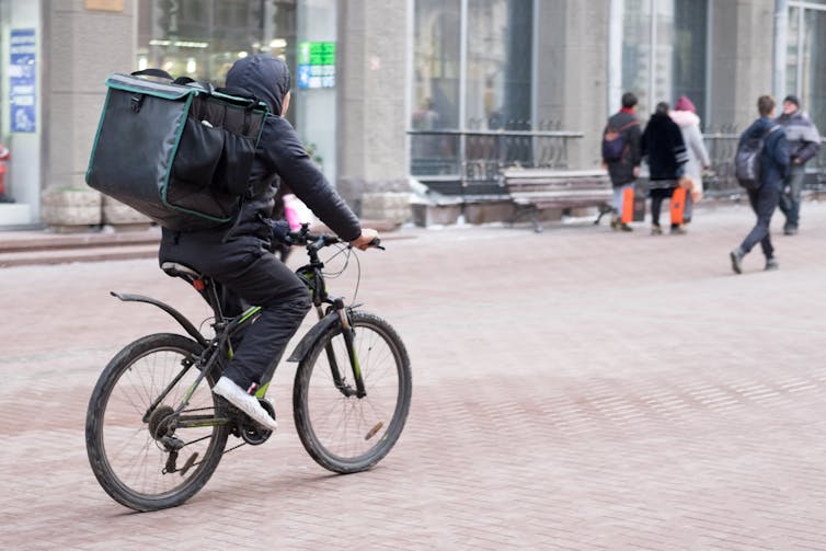 Cyclist with food delivery bag
