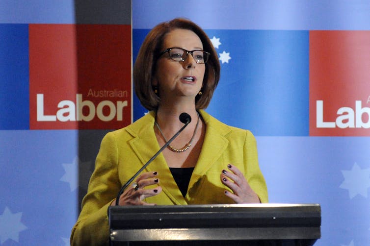 Julia Gillard in front of a Labor sign
