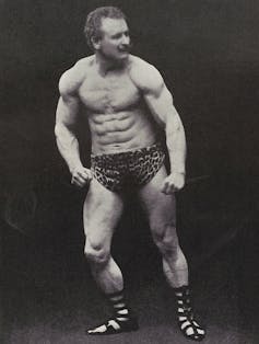 Eugen Sandow wearing leopard-skin trunks and Classical-style sandals.