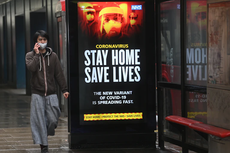 A man walking down a London street during lockdown