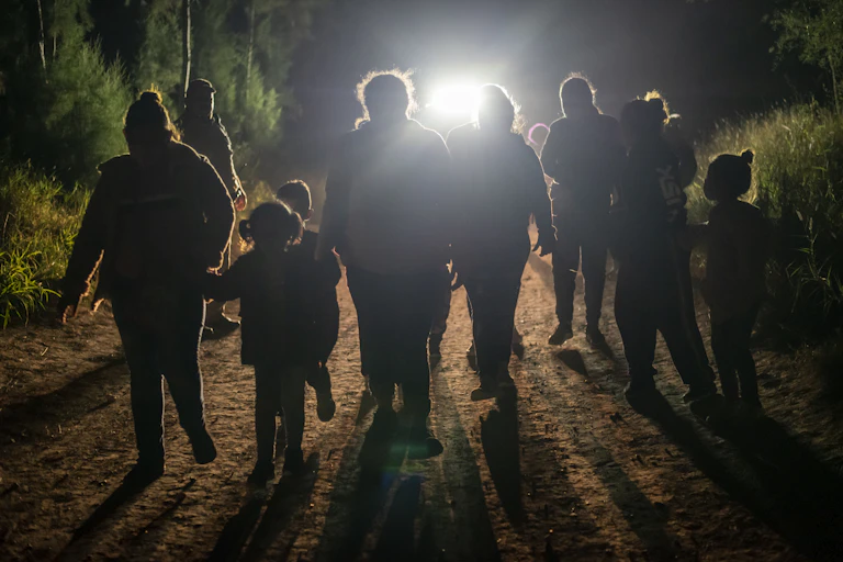 A group of people -- adults and children -- after being apprehended trying to cross into the US near Mission, Texas.
