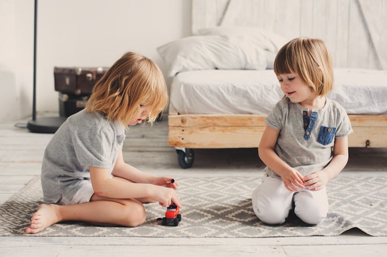 Kids playing with toy train.