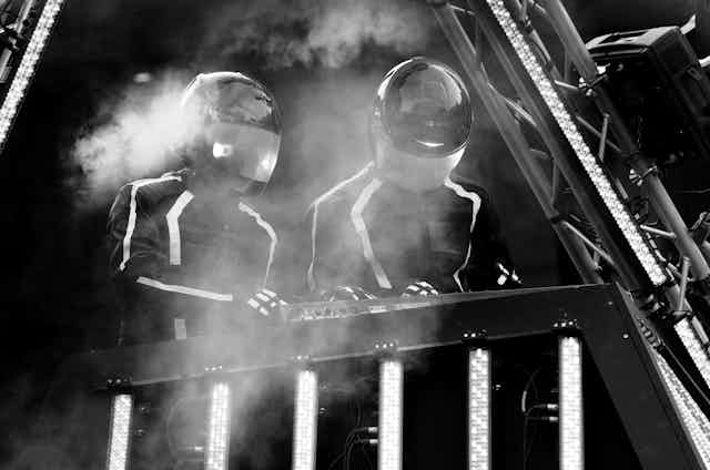 Daft Punk mixing on stage, black and white photo.