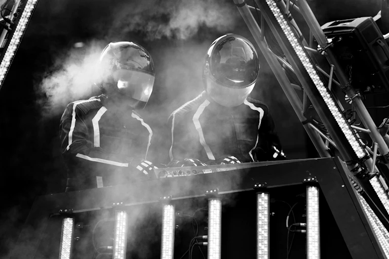 Daft Punk mixing on stage, black and white photo.