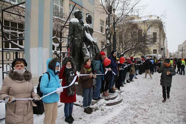 A long line of women protesting in snowy Moscow.