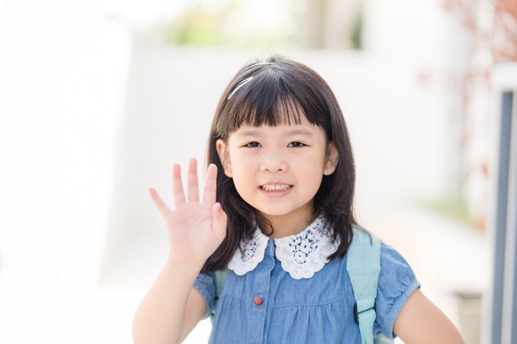 Little girl waving