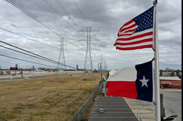 Texas and US flags fly near transmissions linees.