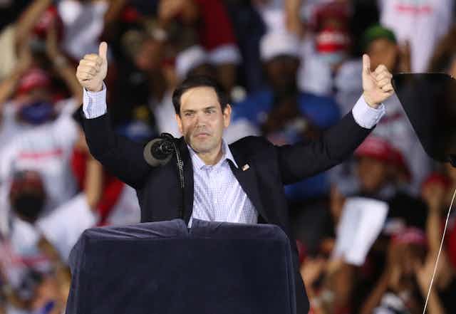 GOP Sen. Marco Rubio at a campaign rally, putting both thumbs up.