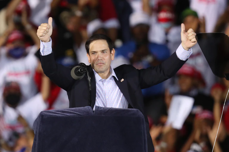 GOP Sen. Marco Rubio at a campaign rally, putting both thumbs up.