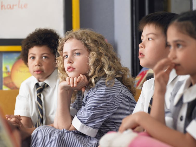 thoughtful young schoolchildren in class