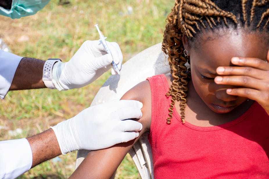 A young girl being vaccinated.