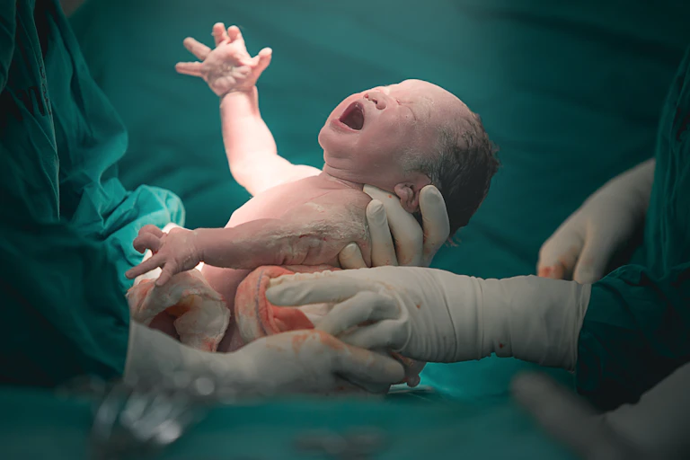 A newborn baby cries.