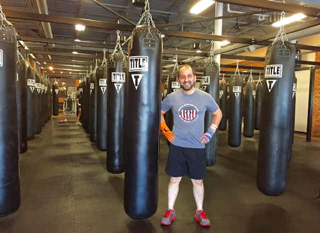 The author standing in front of punching bags.