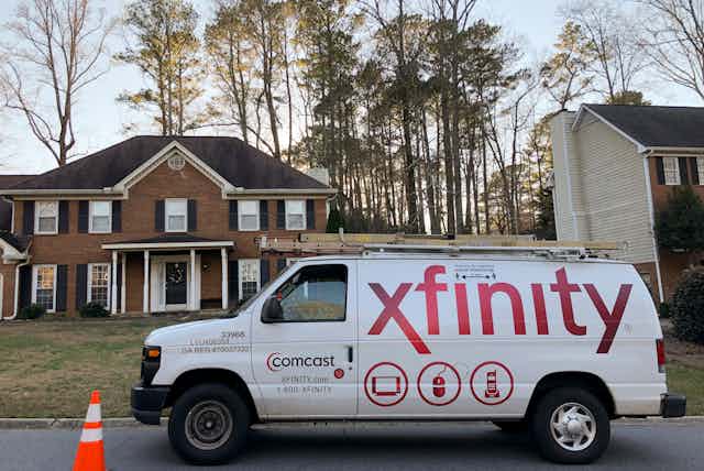 A Comcast van in front of a home
