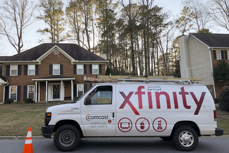 A Comcast van in front of a home