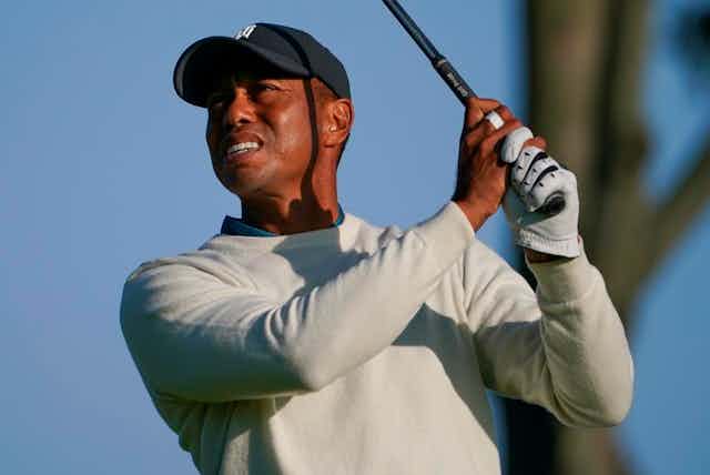 Tiger Woods holding golf club in air