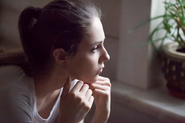 Young woman looking out a window
