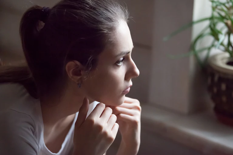 Young woman looking out a window