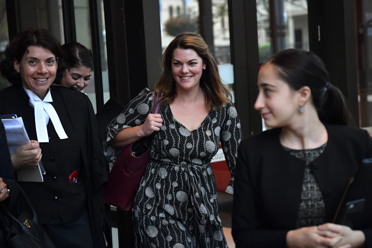 three women including lawyer and client leave court