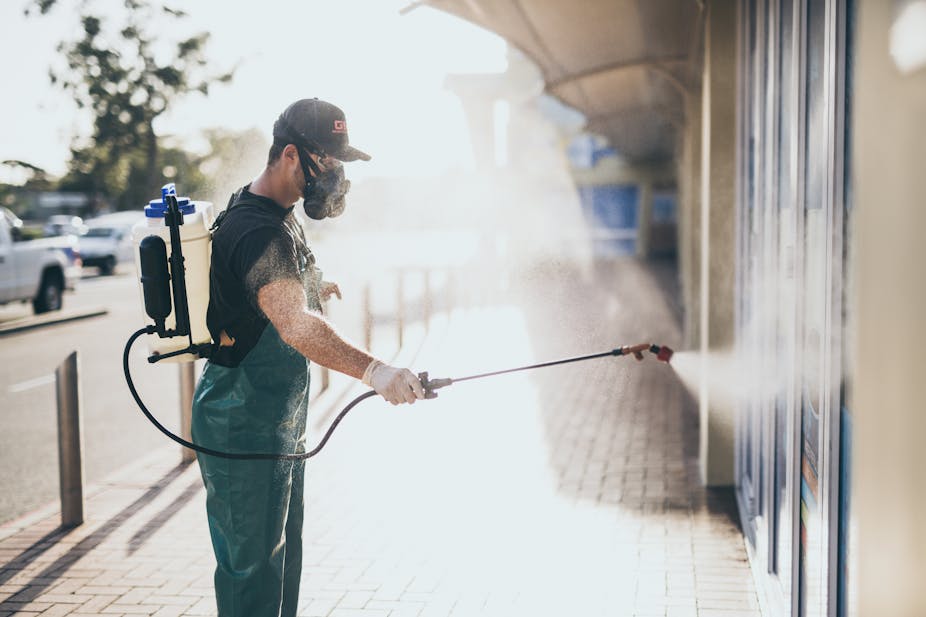 Man disinfecting a public space
