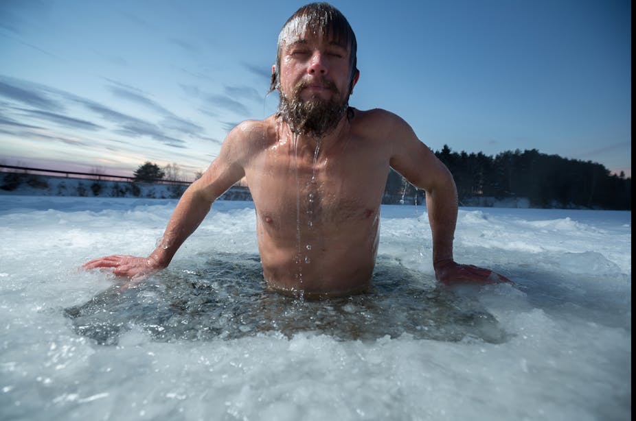 Man emerging from icy water.