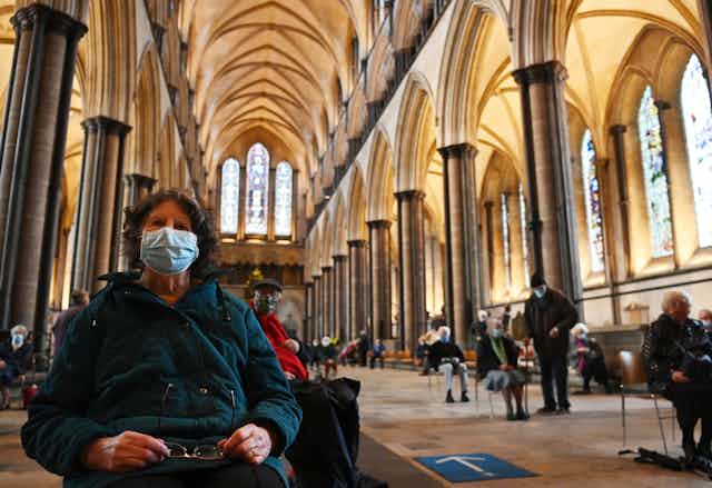 A woman waiting for a COVID-19 vaccination in Salisbury cathedral, UK