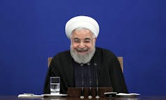 Iran's President Hassan Rouhani smiles