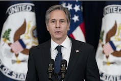 Secretary of State Antony Blinken speaks at a podium.