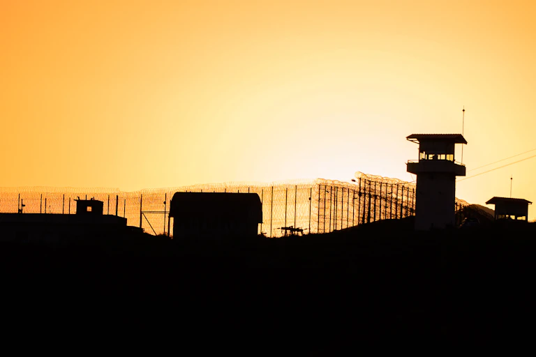 Silhouette of jail at sunset
