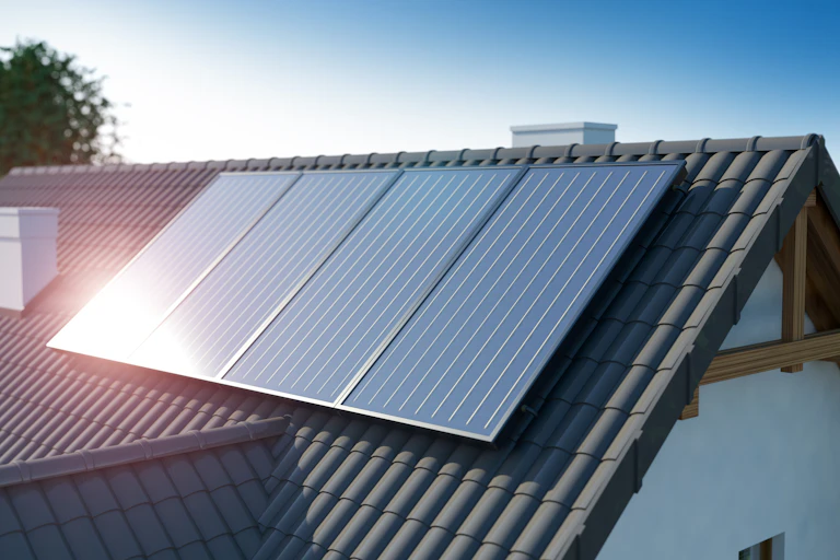 A roof with solar panels on it, reflecting the sun.