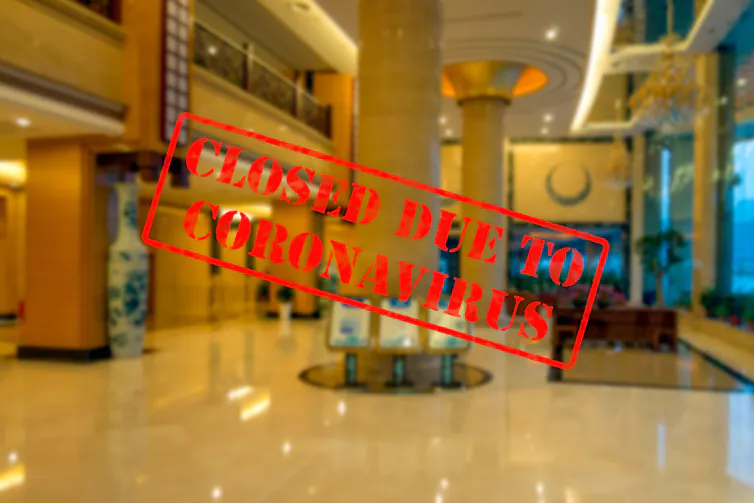 Empty hotel lobby with a 'closed for coronavirus' sign