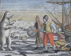 A polar bear lunges at men near a ship frozen in ice
