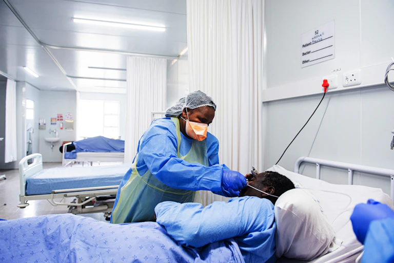 A health worker tending to a patient