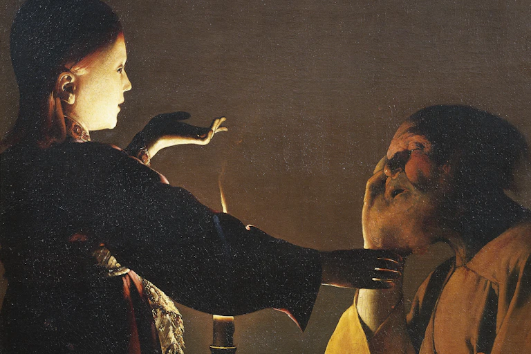 A girl reaches out to touch an elderly man who's sleeping.