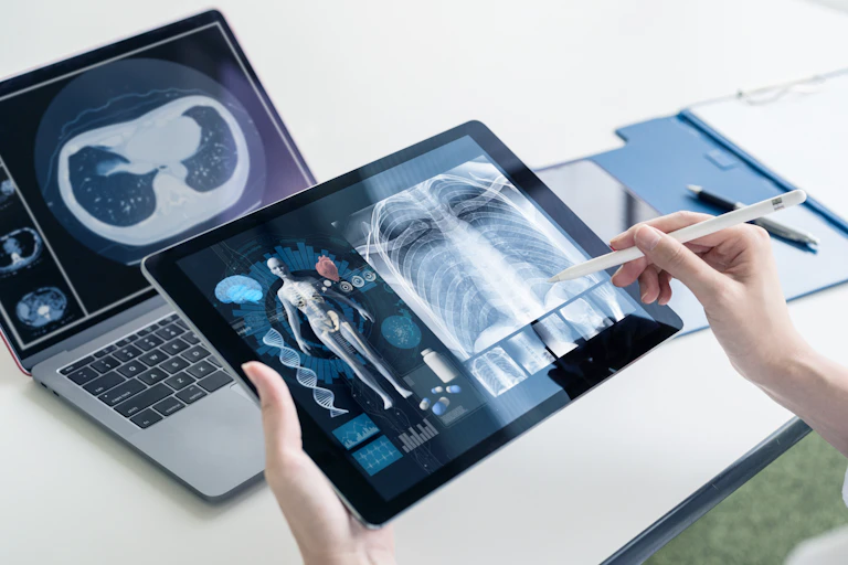A tablet and laptop displaying medical information