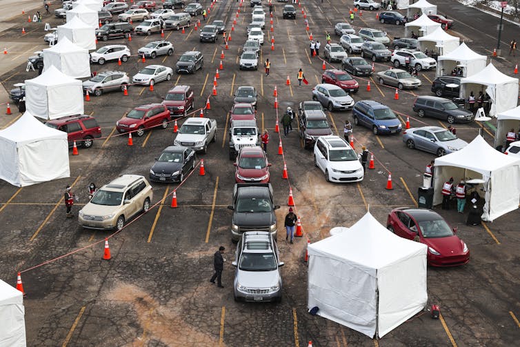 Cars lined up at an outdoor vaccination site.