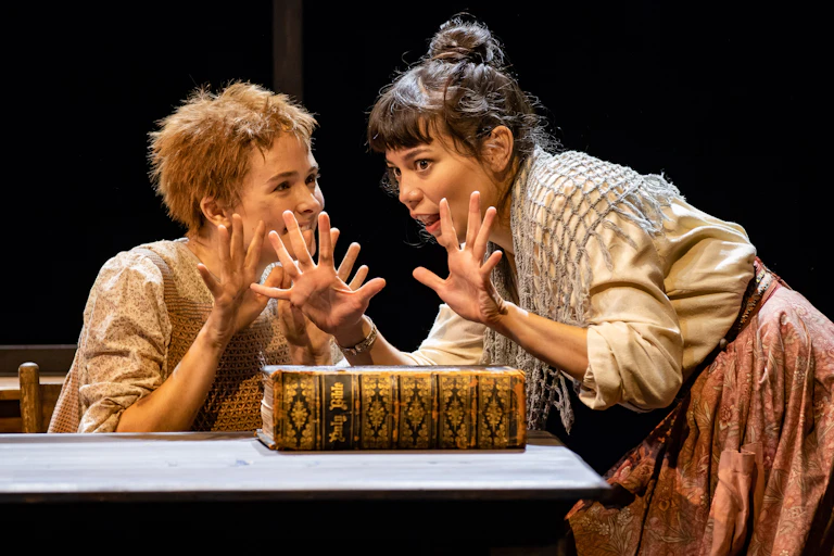 Two young women talk and smile