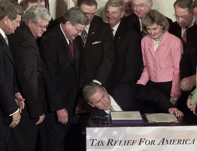 President George W. Bush dropped a pen while signing the 2001 tax cut bill.