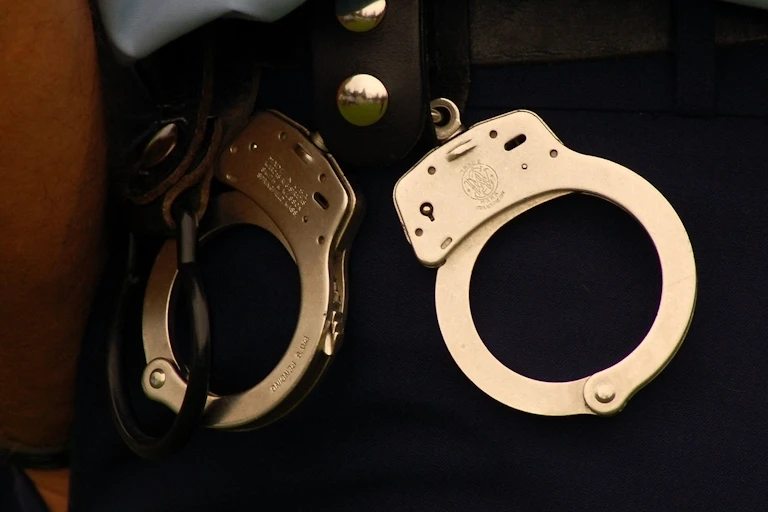 A pair of handcuffs on a New Zealand police officer's belt.